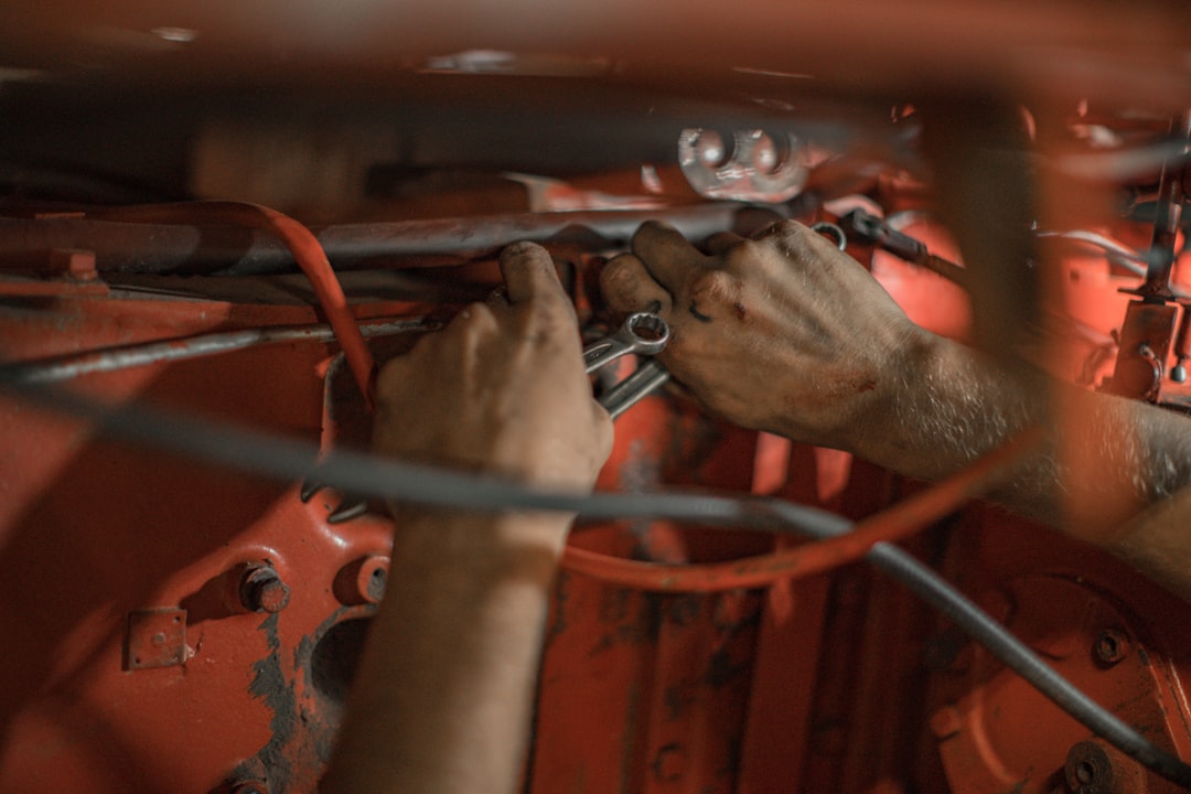 Hands adjusting a small electronic device mounted inside a car
