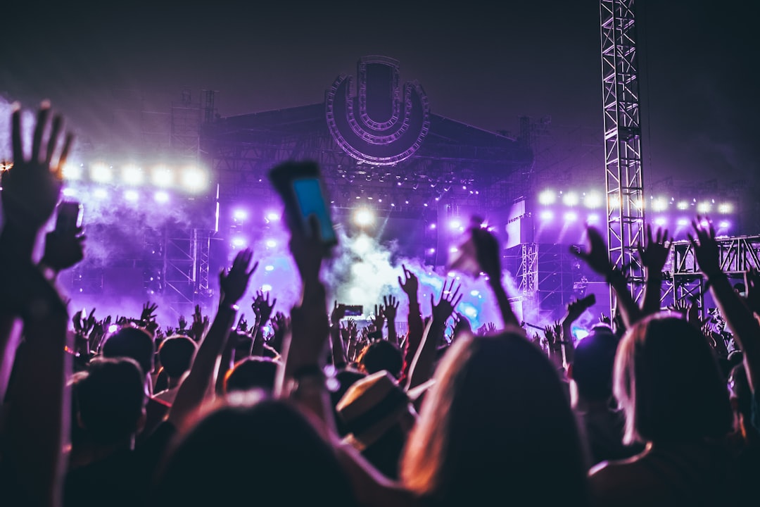 Concert crowd holding up phones to film the stage