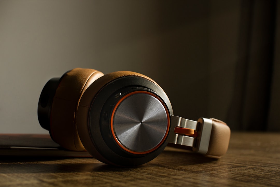 Modern over-ear headphones resting on a wooden table
