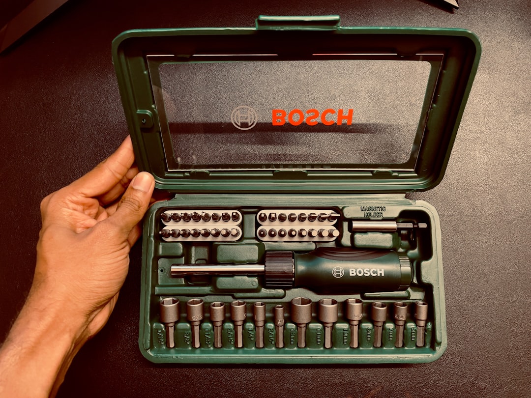 Precision screwdriver bits arranged in a repair kit