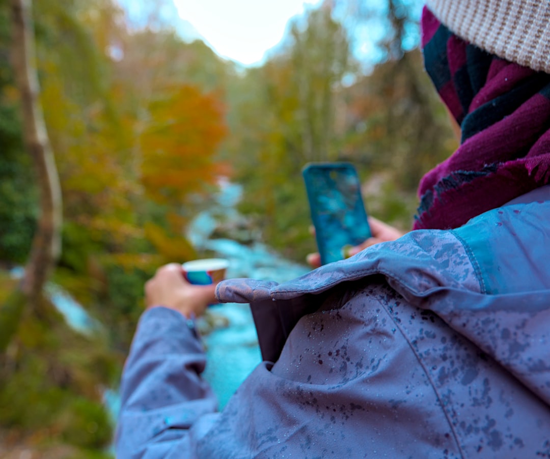 Person using a modern smartphone outdoors