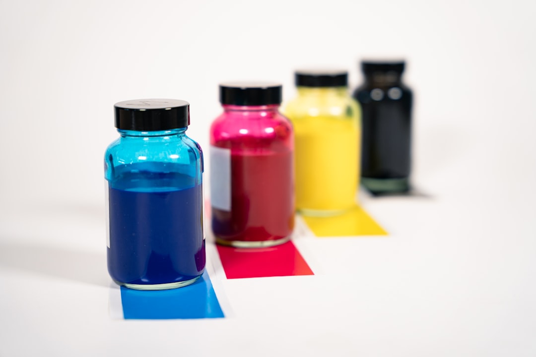 CMYK ink bottles and color swatches