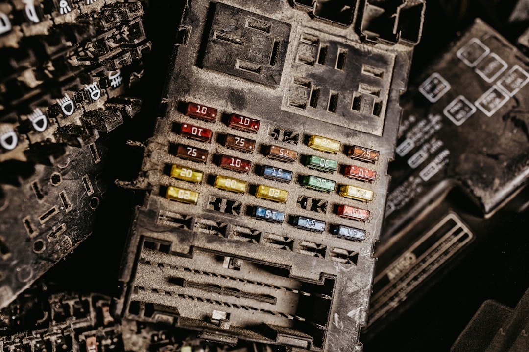 Open car fuse box showing wiring and electrical connections