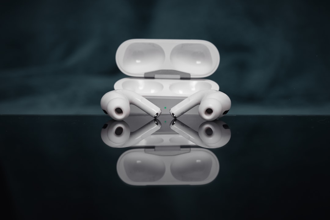 Wireless earbuds resting in their charging case