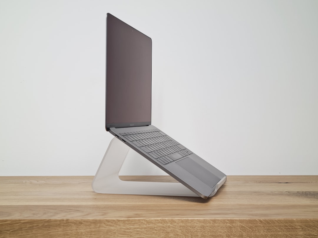 Aluminum laptop stand on desk elevated to eye level