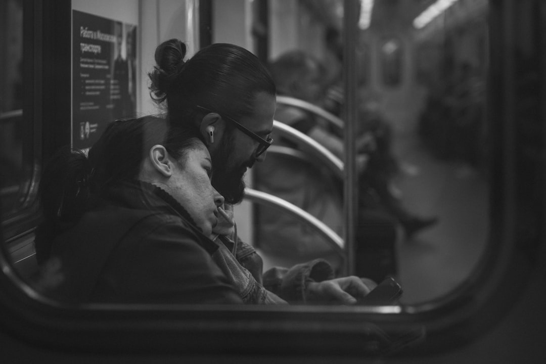 Commuter listening to music beside a train window