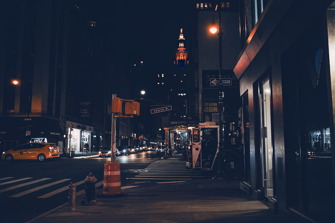 Car parked on a city street at night with ambient city lighting