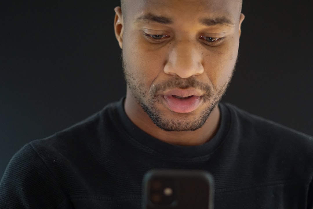 A person unlocking a smartphone with face recognition