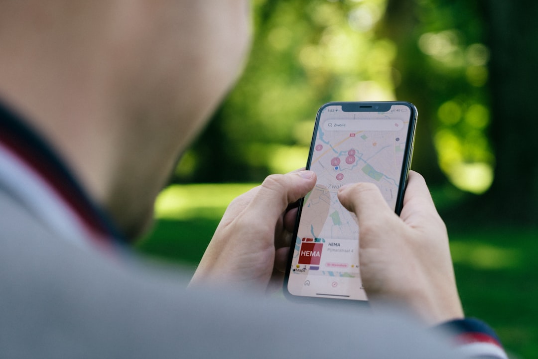 Hands holding a smartphone showing a map navigation app
