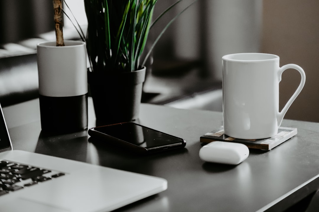 Wireless earbuds in charging case on desk
