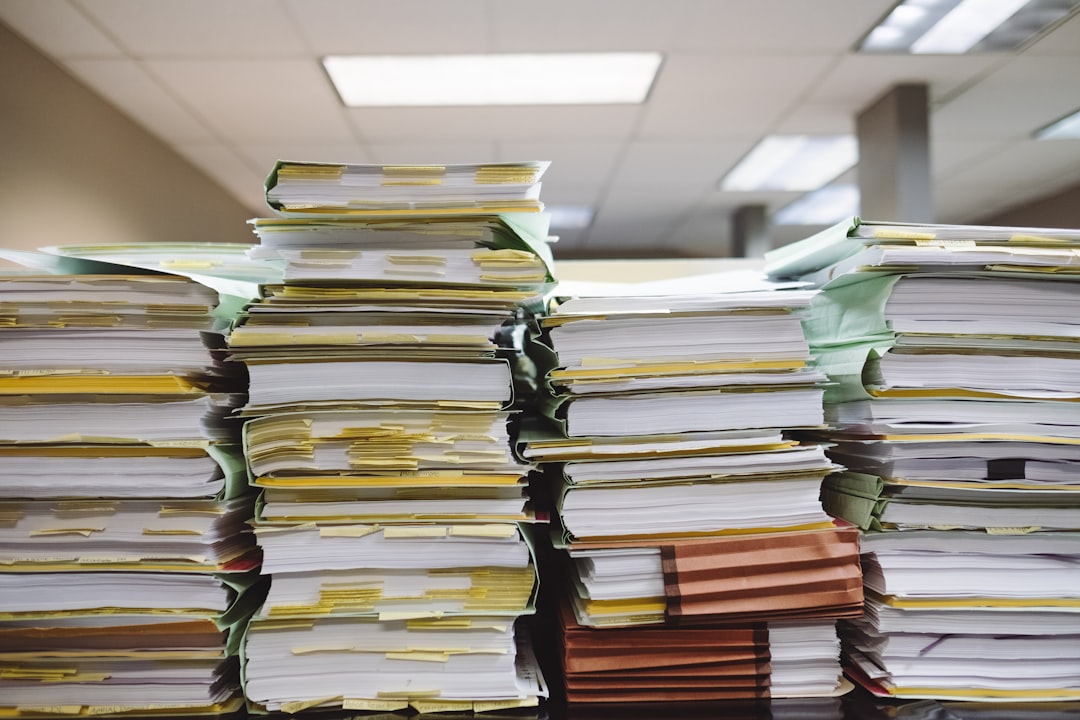 Stacked printed documents on a desk