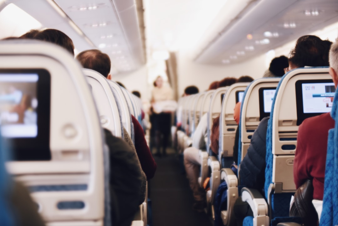 Airplane passenger seated by the window during a flight