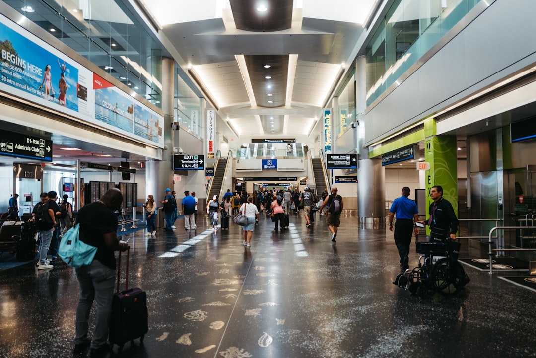 Traveler waiting in airport terminal with laptop open