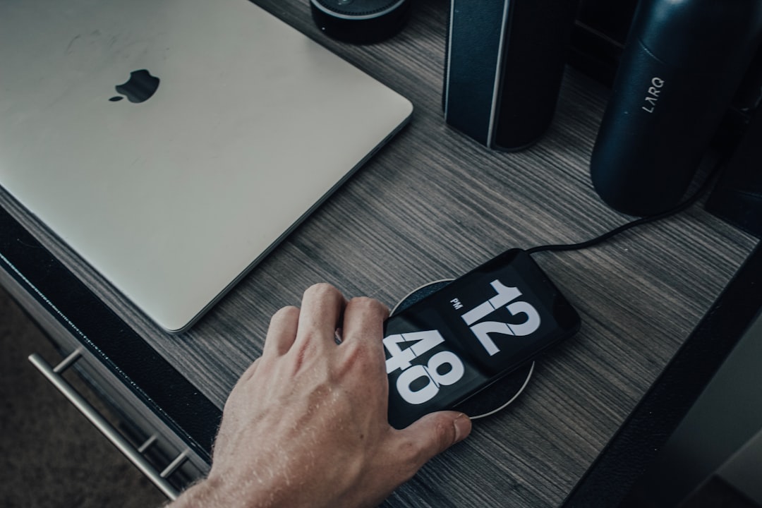 Hand placing a phone onto a wireless charging pad