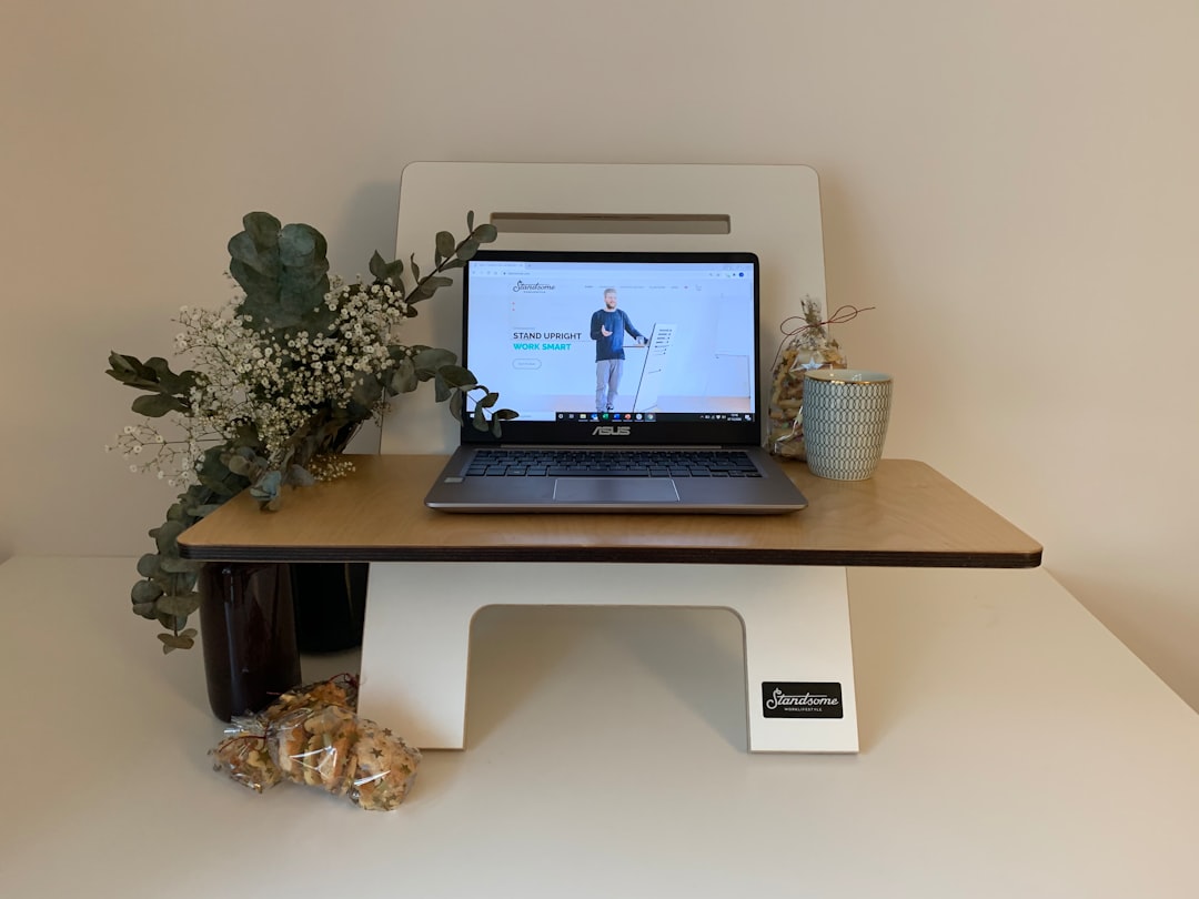 A laptop raised on a stand at desk level