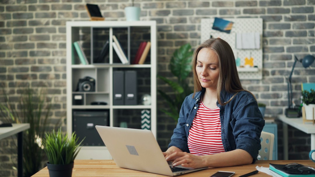 Writer working on a laptop in bright daylight
