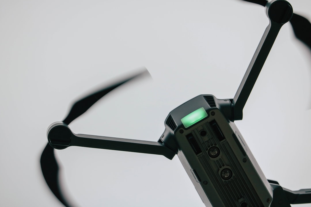 Closeup of a modern consumer drone with arms extended, motors and sensors visible