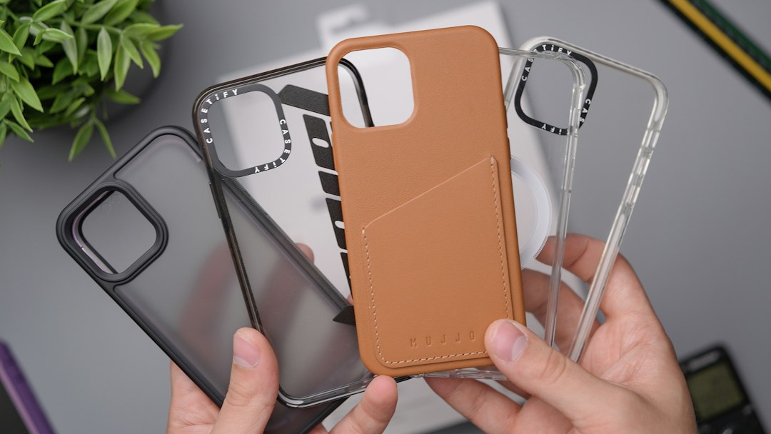 Hands holding several phone cases in different styles
