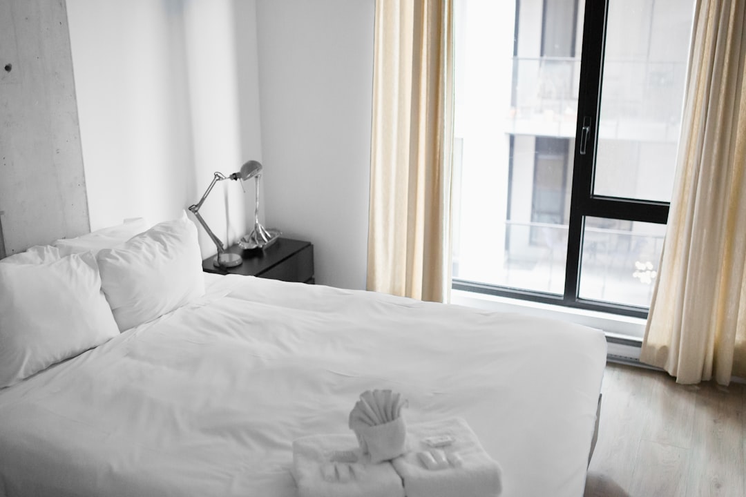 Bright minimalist hotel room with a white bed