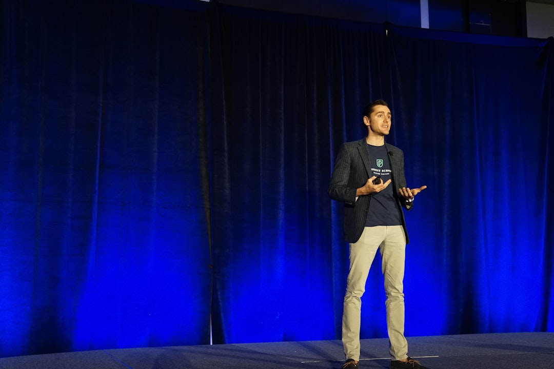 Presenter speaking on a conference keynote stage
