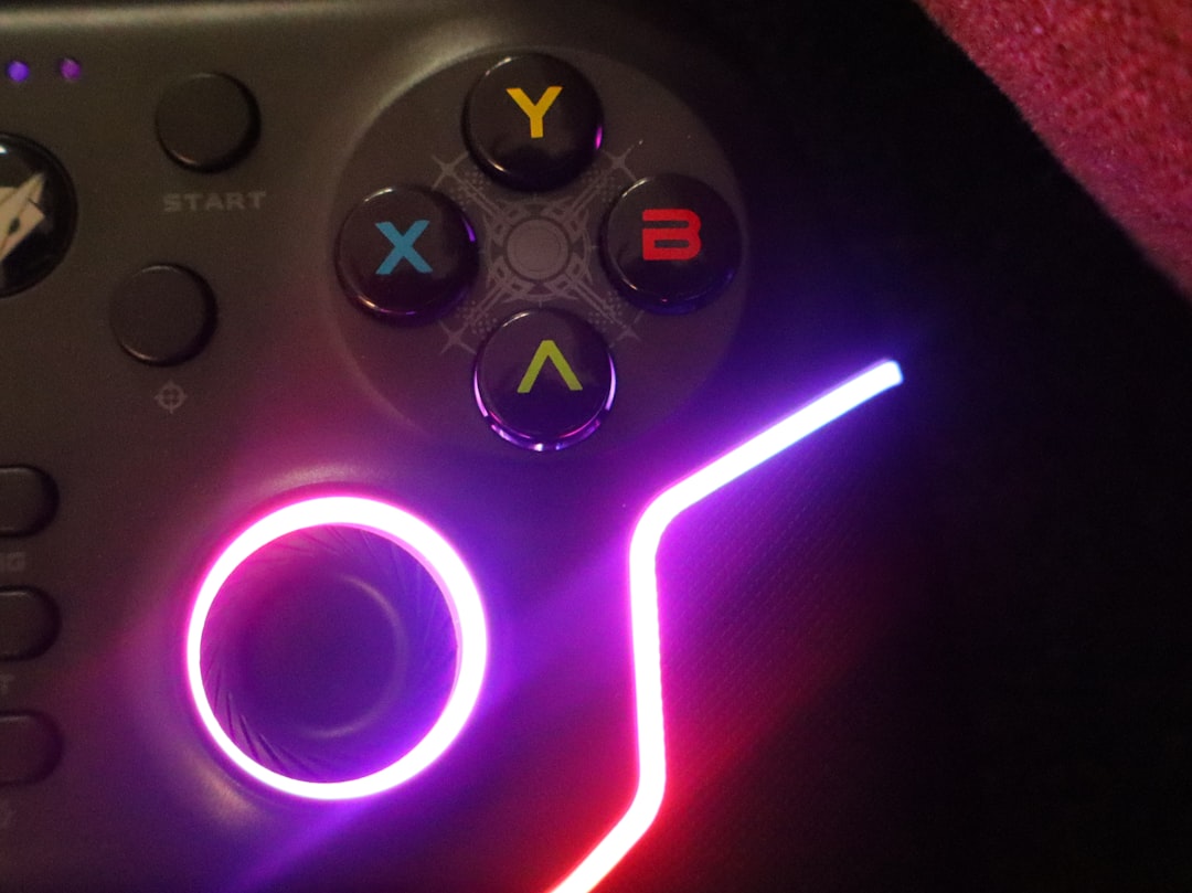Game controller analog stick lit in purple and pink neon