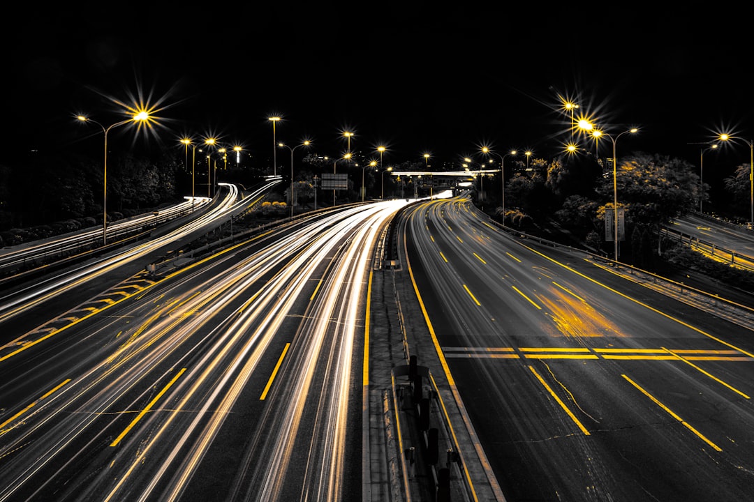 Night highway with headlight trails