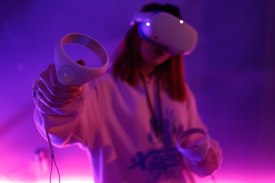 Person wearing a white VR headset in a purple-lit room