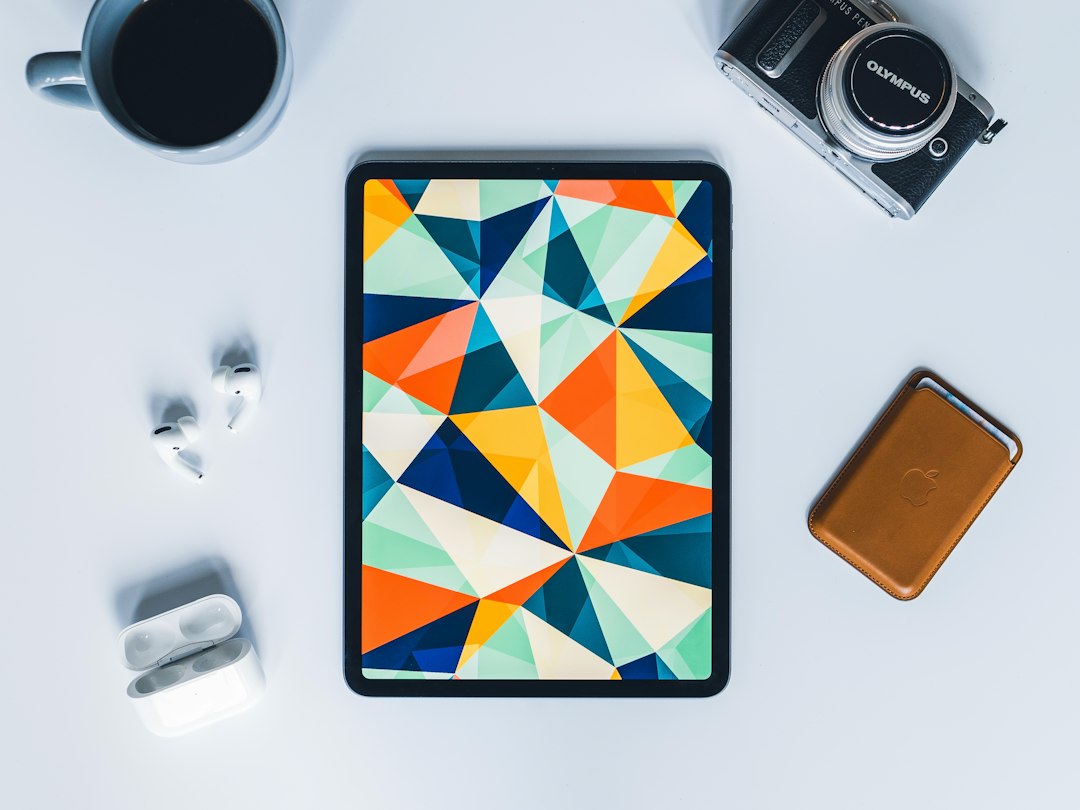 Color tablet device resting among accessories on a bright surface
