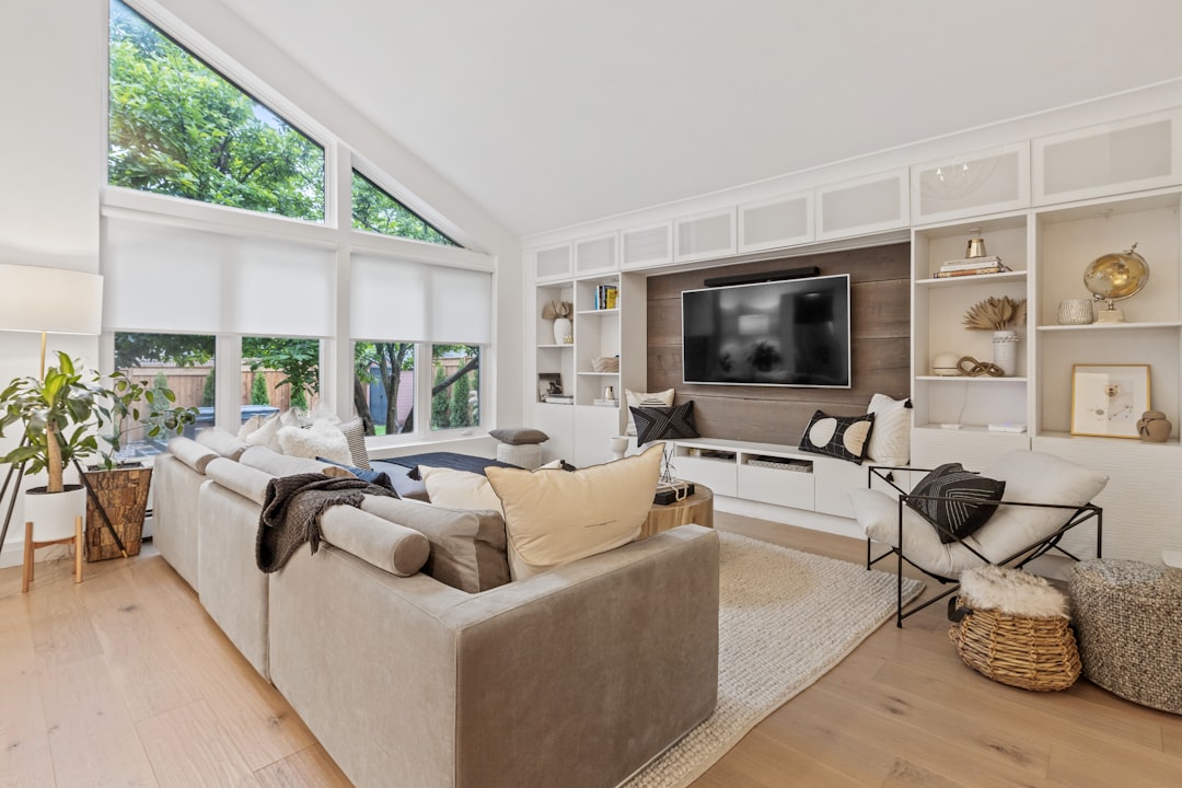 Living room with a large TV wall-mounted on a wood-paneled accent wall