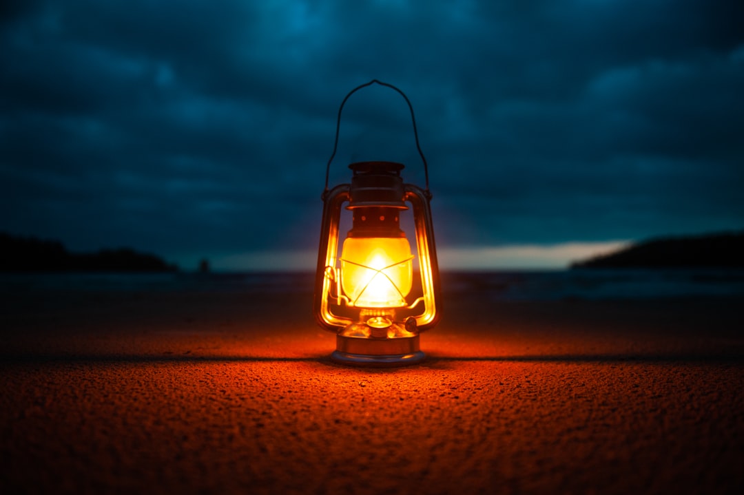 Rechargeable LED lantern glowing on the ground at night