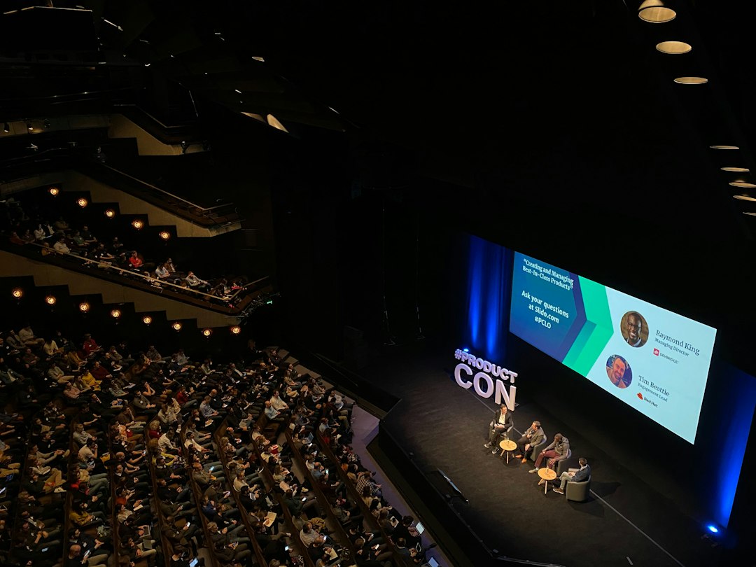 Conference audience applauding at a tech keynote