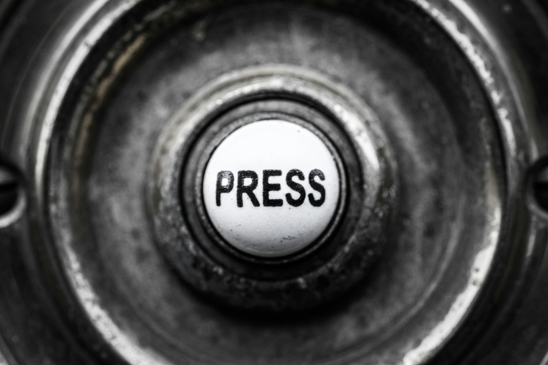 Close-up of a metal button labeled press