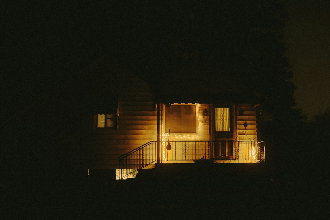 Warm string lights glowing across a porch at night