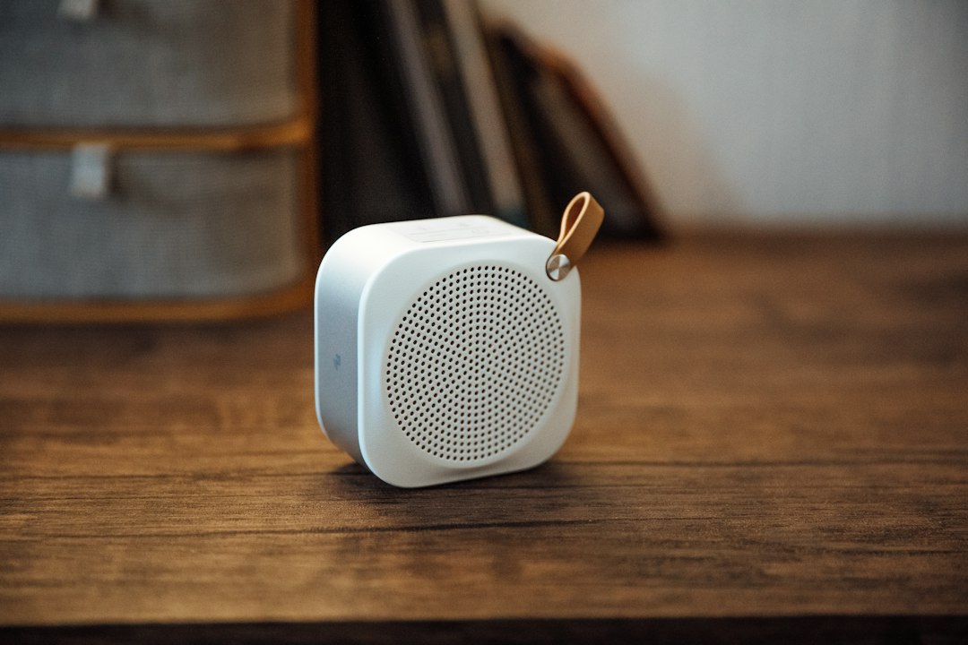 Small bluetooth speaker on a wooden desk