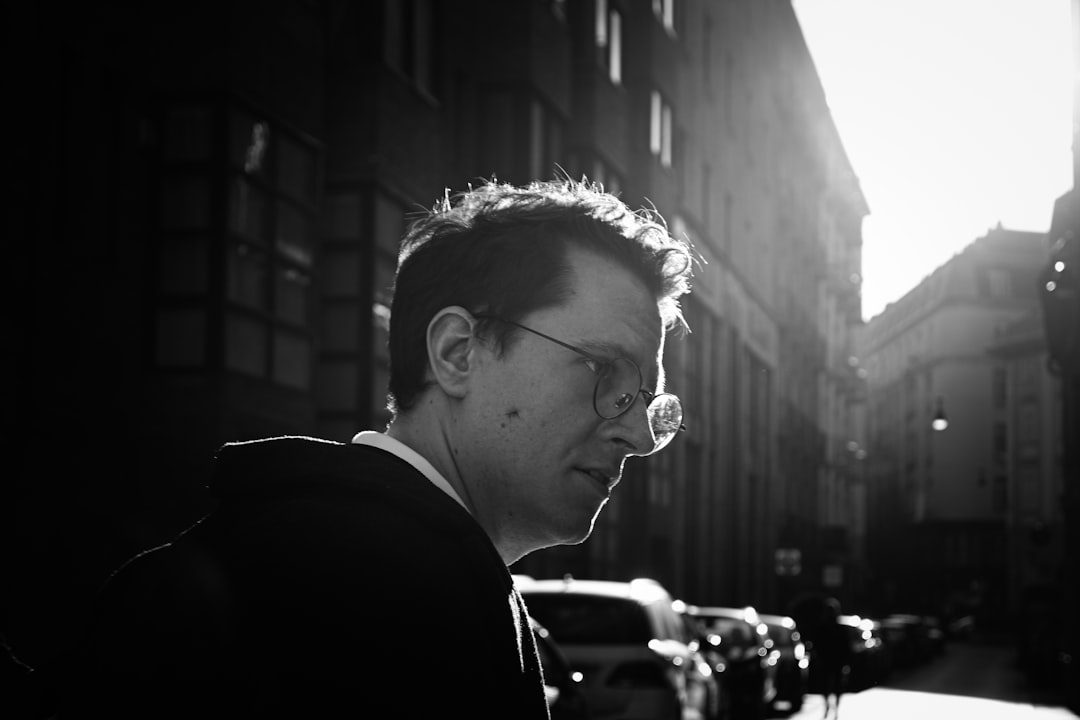 Man wearing clear-lens glasses on a city street