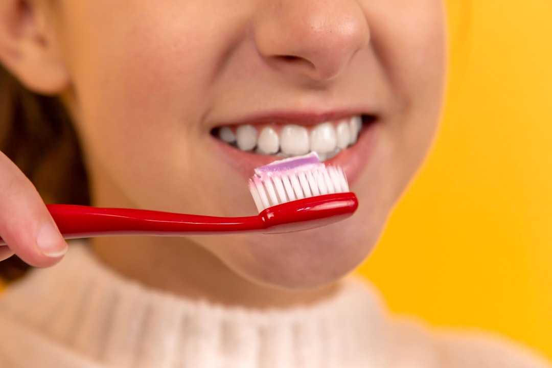 Person brushing teeth at a bathroom mirror