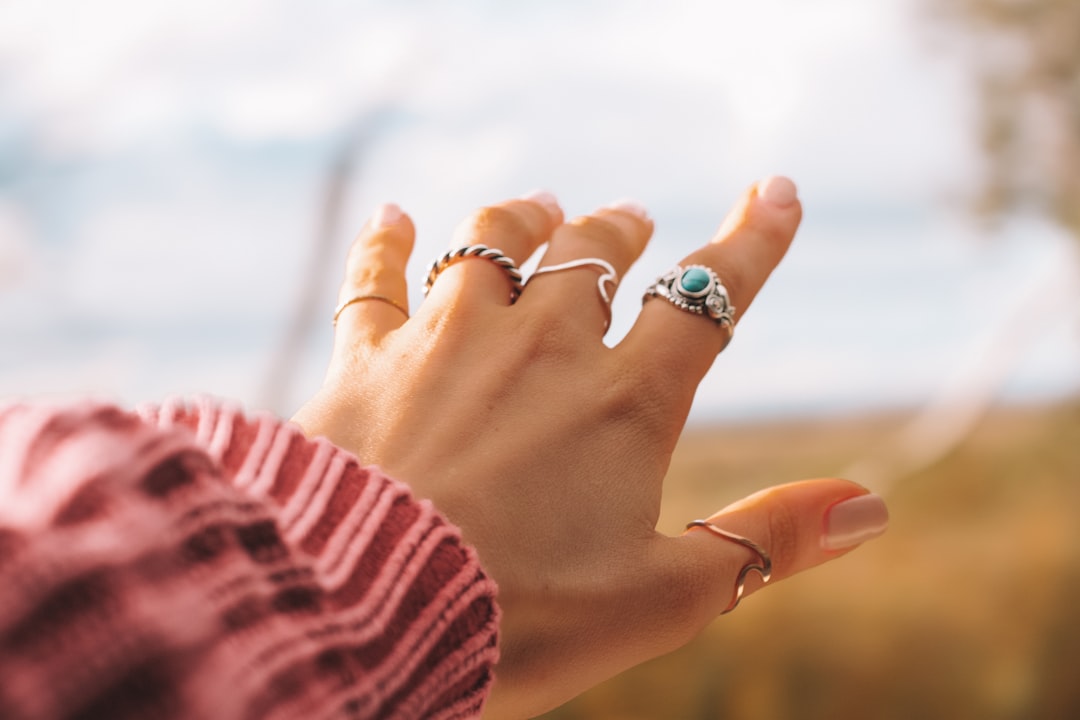 Hand wearing several rings