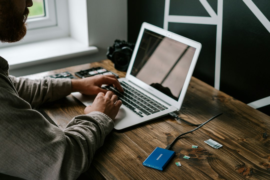 Laptop connected to a portable external SSD on a desk