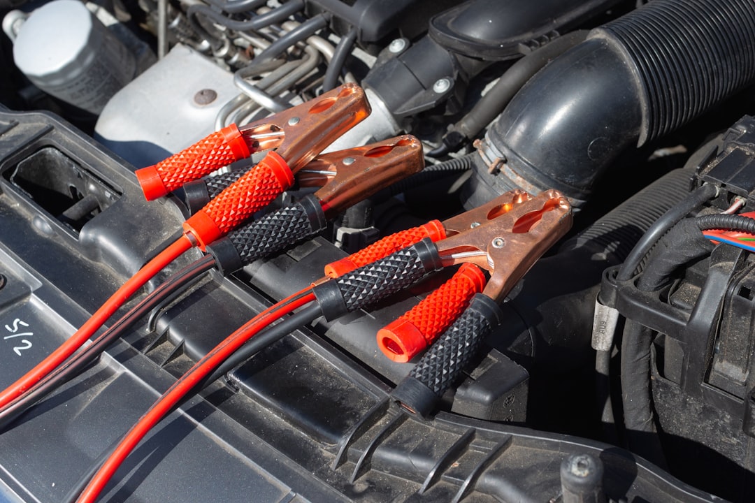 Jumper cables connected to a car battery in the engine bay