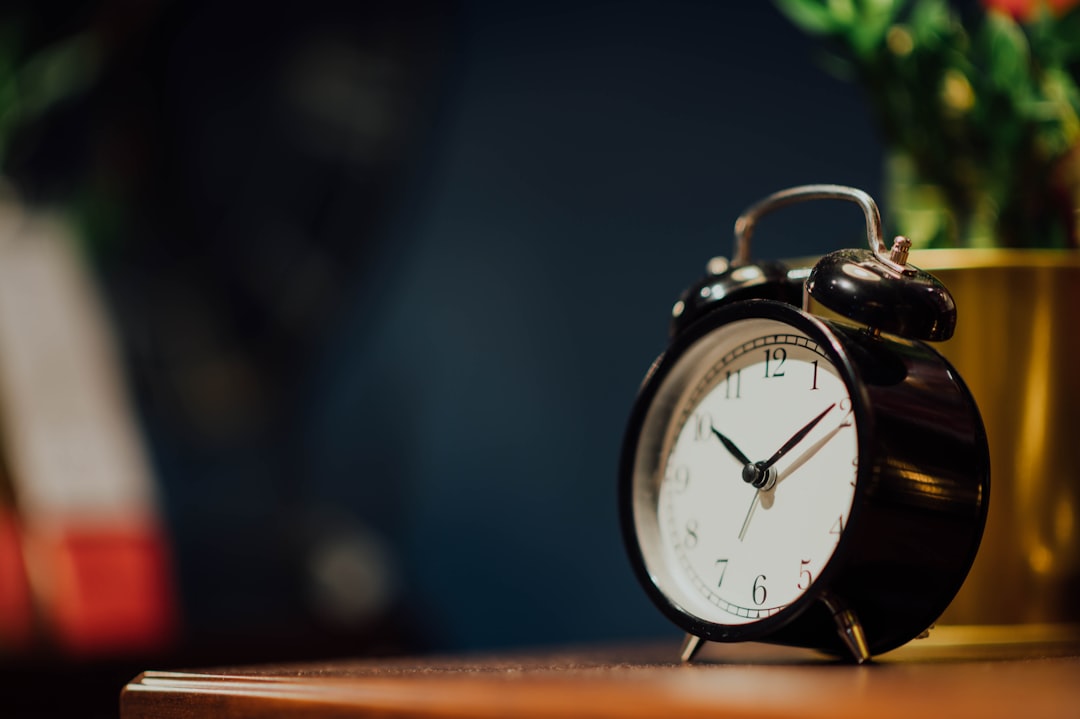 Twin-bell alarm clock against a dark background