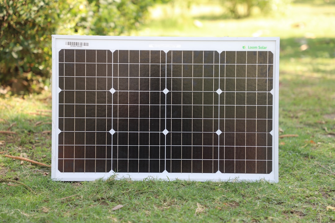 Portable solar panel lying on grass in sunlight