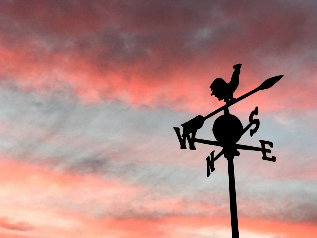 Traditional weather vane against a sunset sky