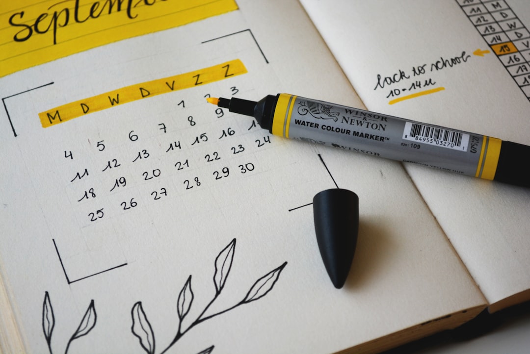 Handwritten paper calendar with notes and highlights