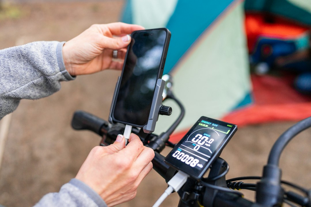 A phone charging from a compact power bank outdoors