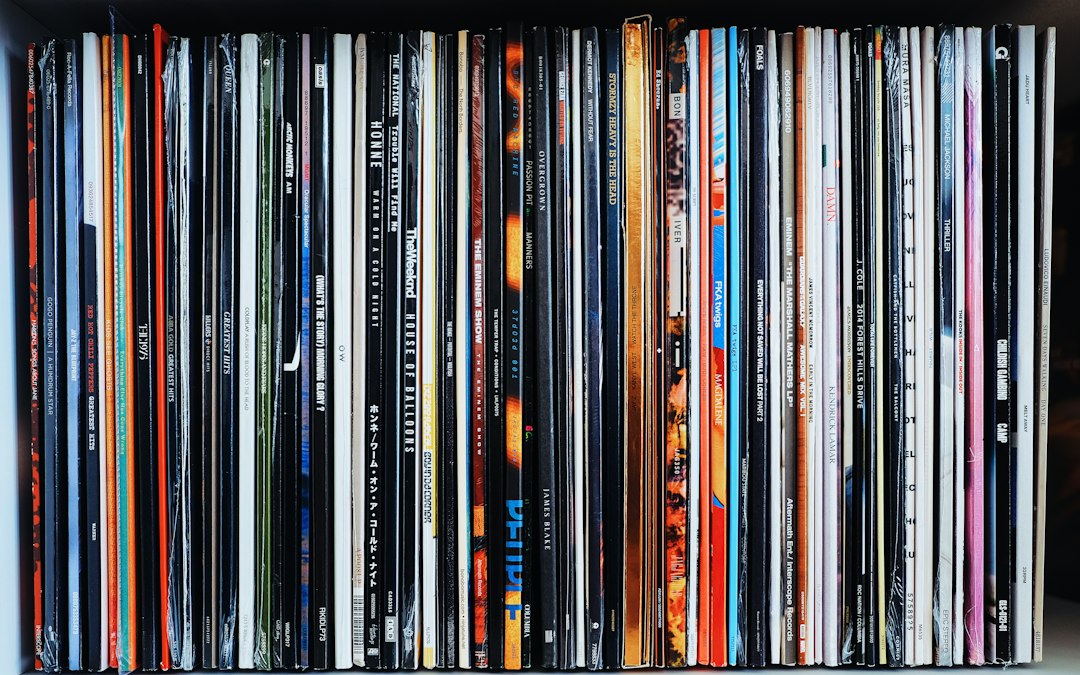 Rows of vinyl record spines on a shelf