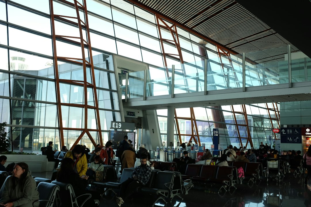 Travelers waiting in an airport terminal departure area