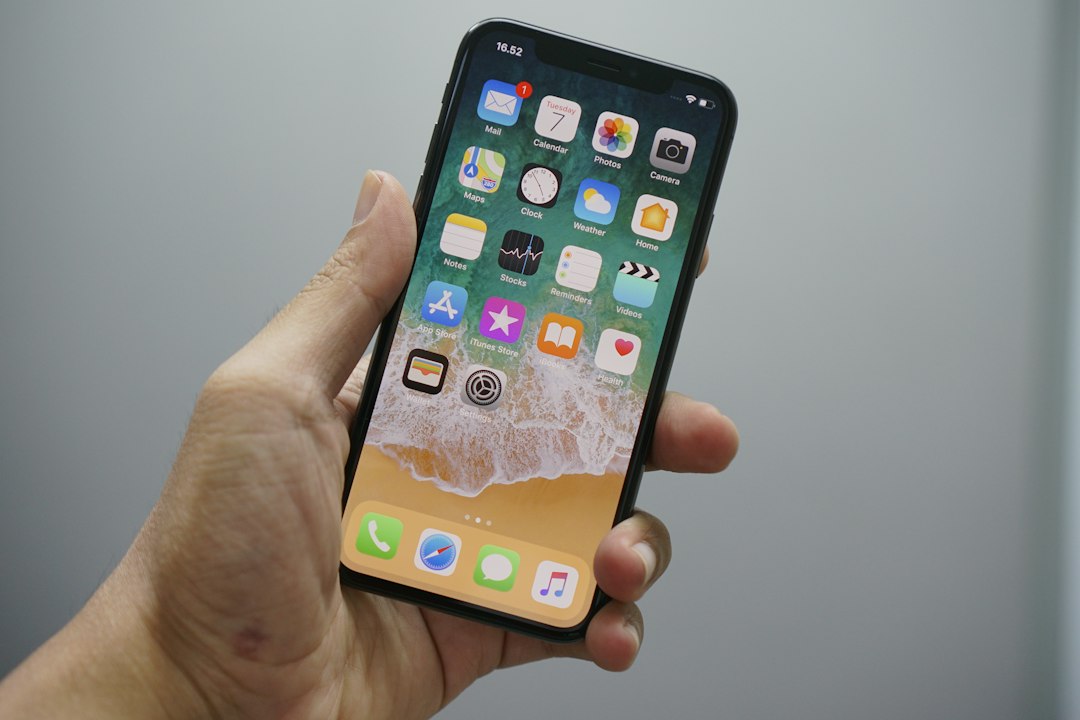 A finger tapping an app store screen on a smartphone