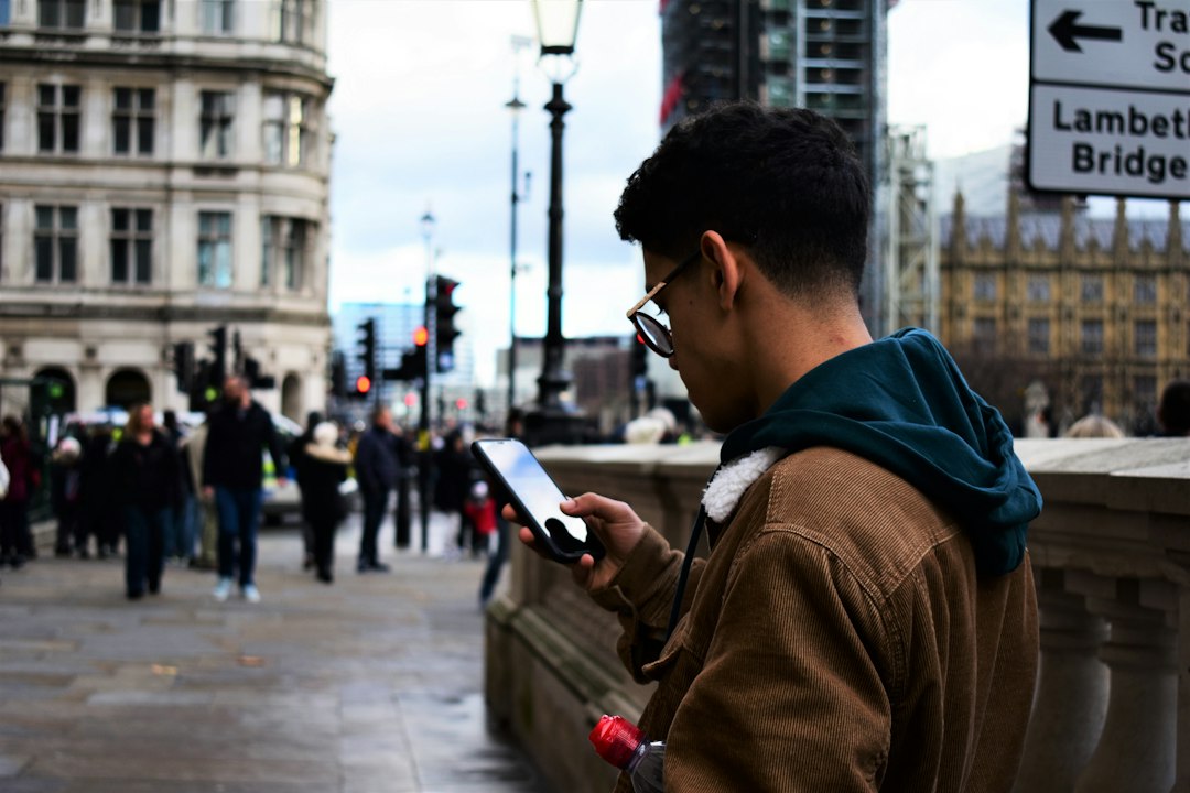 Traveler checking his smartphone on a busy city street