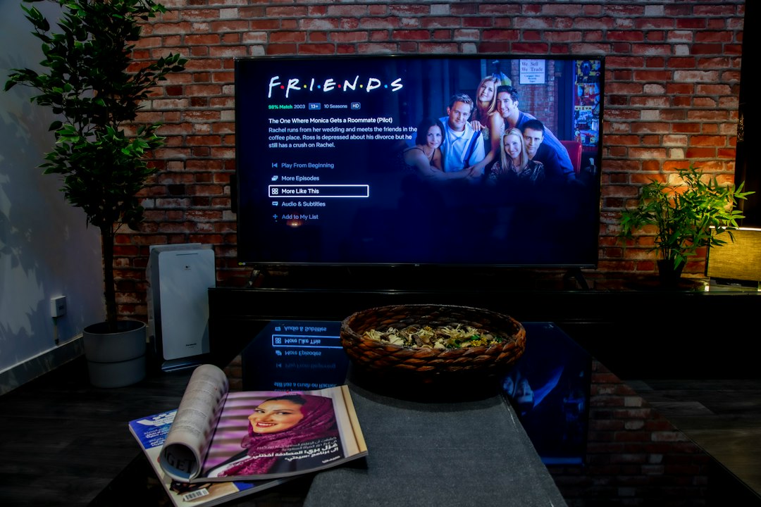 Cozy living room with a large television, snack basket, and open magazine on the coffee table