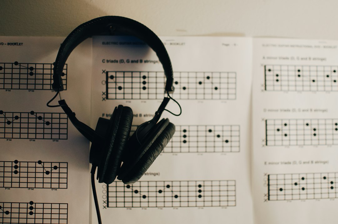 Over-ear headphones set down on printed music, off the head